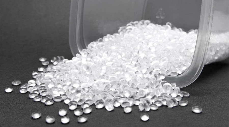 Clear plastic pellets pouring out of a container representing HDPE material Clear plastic pellets pouring out of a container representing HDPE material