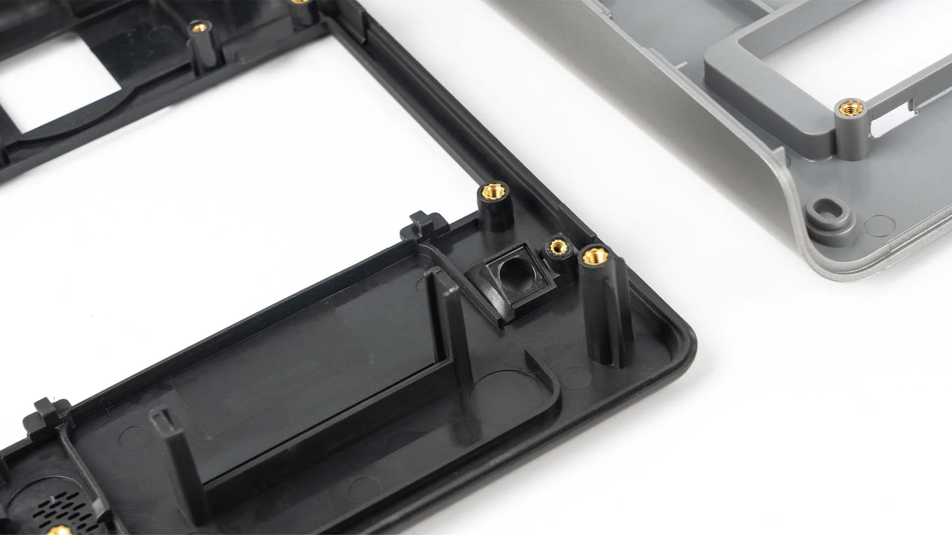 Close up of plastic case with metal inserts and fasteners Close up of plastic case with metal inserts and fasteners