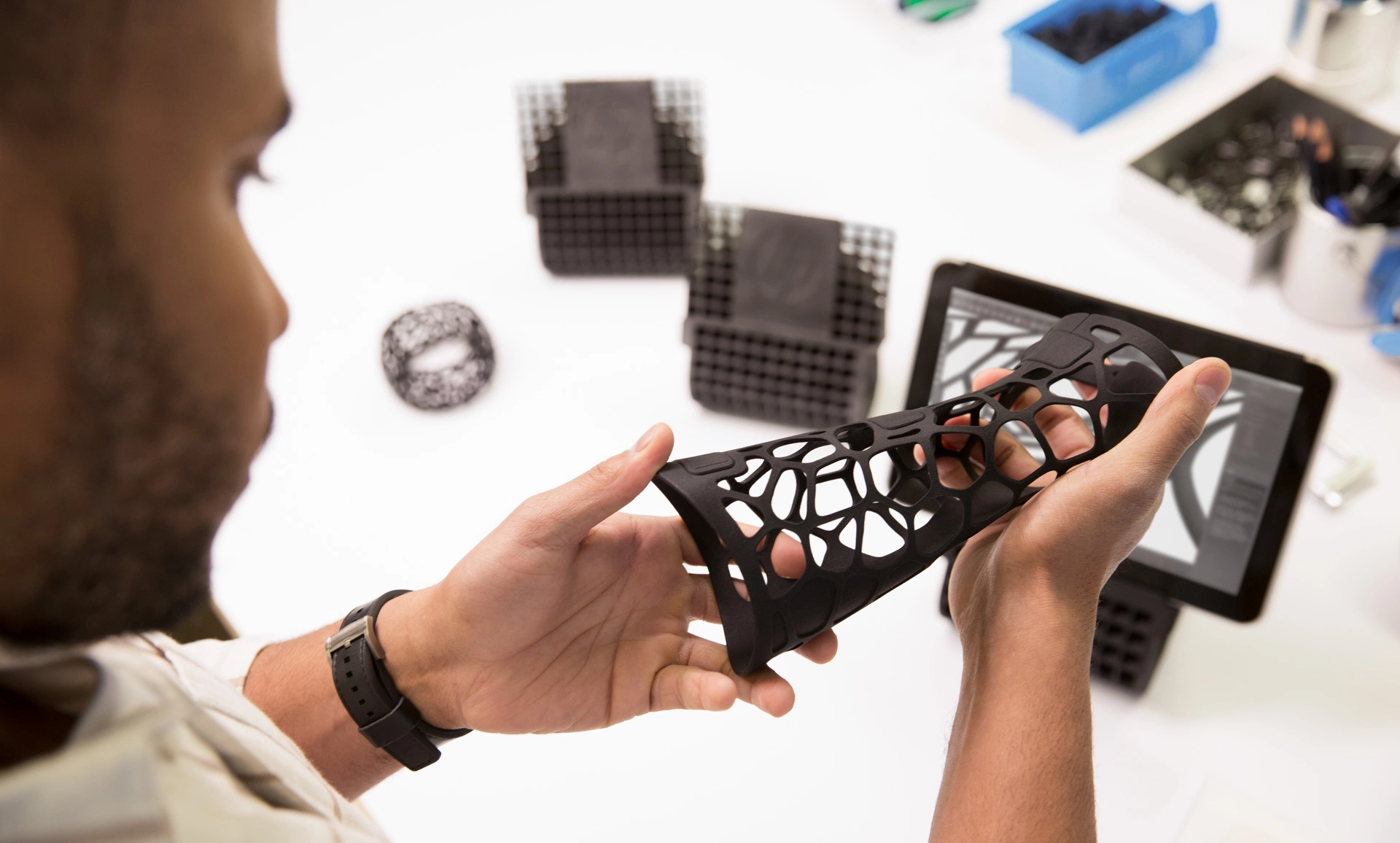 Designer inspecting a flexible 3D printed prototype part Designer inspecting a flexible 3D printed prototype part