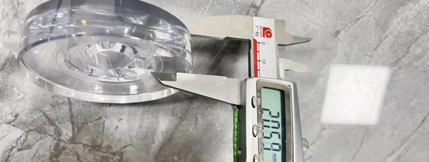 Digital caliper measuring the wall thickness of a clear plastic part Digital caliper measuring the wall thickness of a clear plastic part