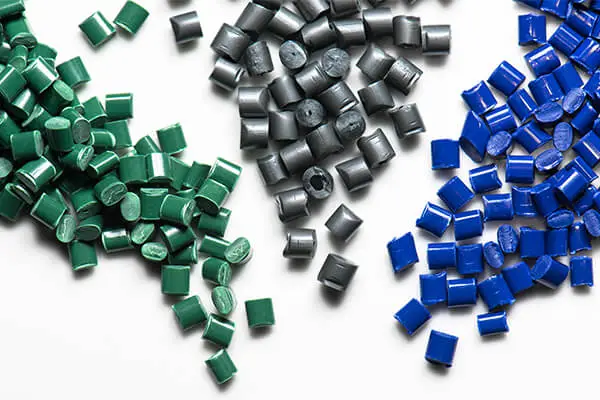 Green grey and blue plastic pellets used for low volume injection molding Green grey and blue plastic pellets used for low volume injection molding
