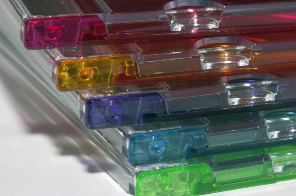 Stacked colorful plastic cases highlighting material transparency Stacked colorful plastic cases highlighting material transparency