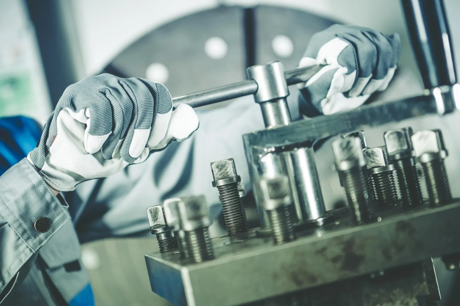 Workers hands with gloves on molding machine